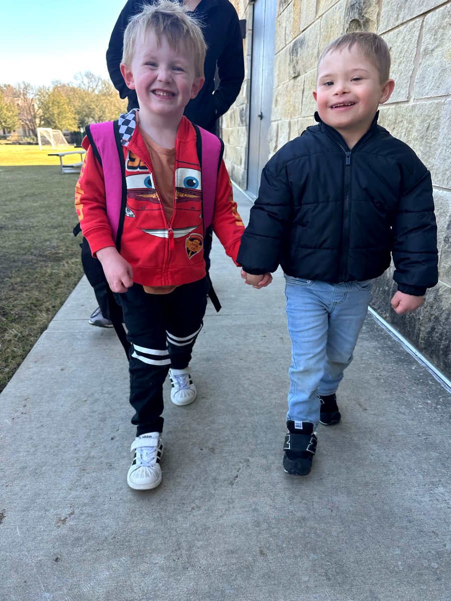 Two young friends arm in arm at Millie's Place Academy