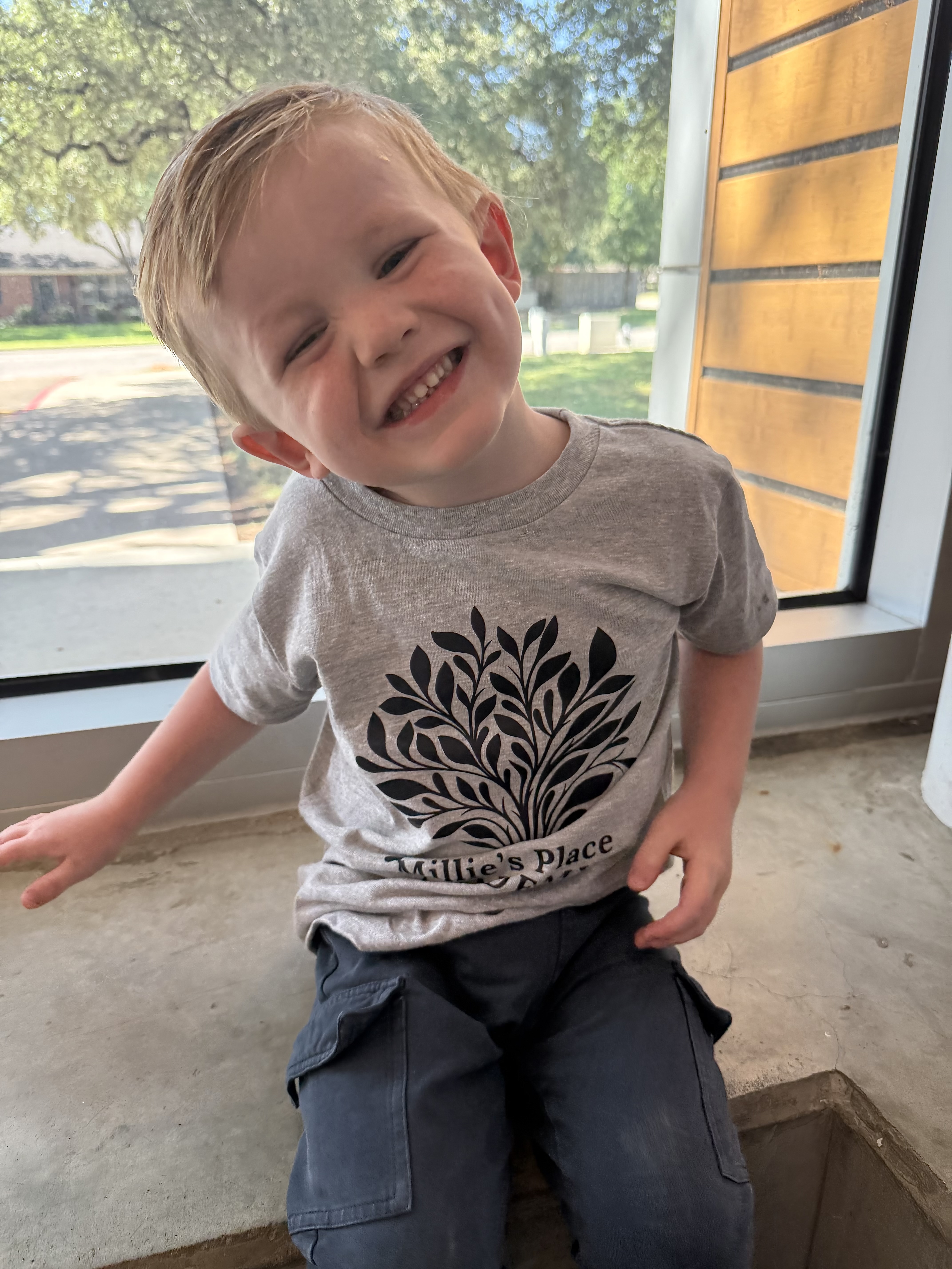 Harrison smiling on the playground at Millie's Place Academy